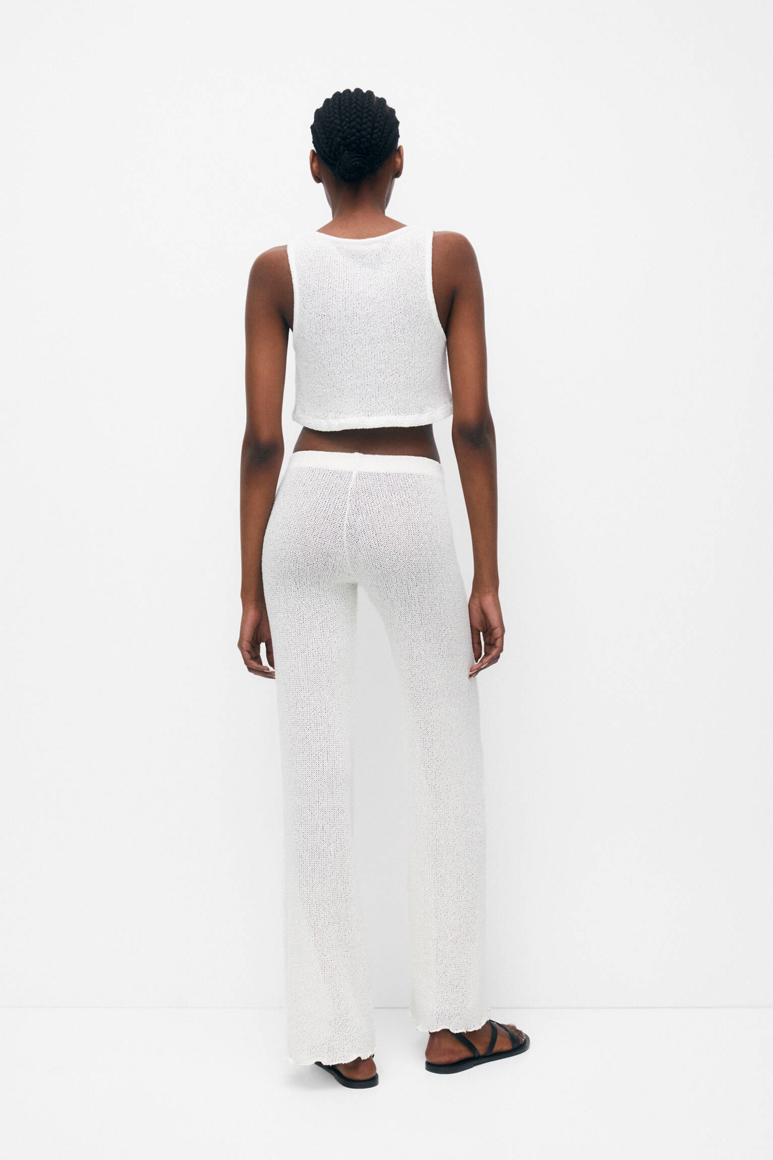 Calça de malha com corte flare - Crua