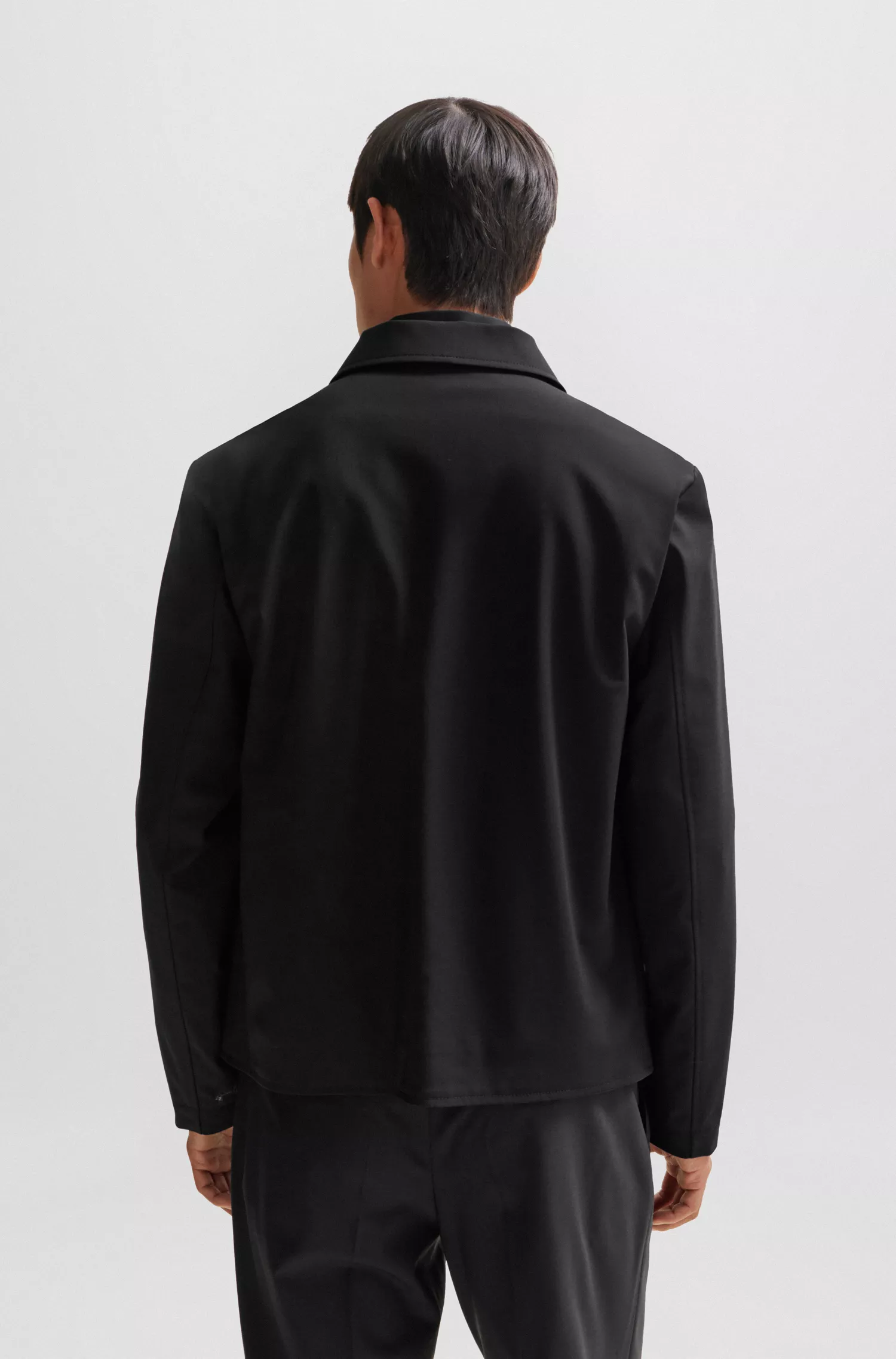 Jaqueta BOSS preta de corte slim em mistura de lã elástica de alta performance.