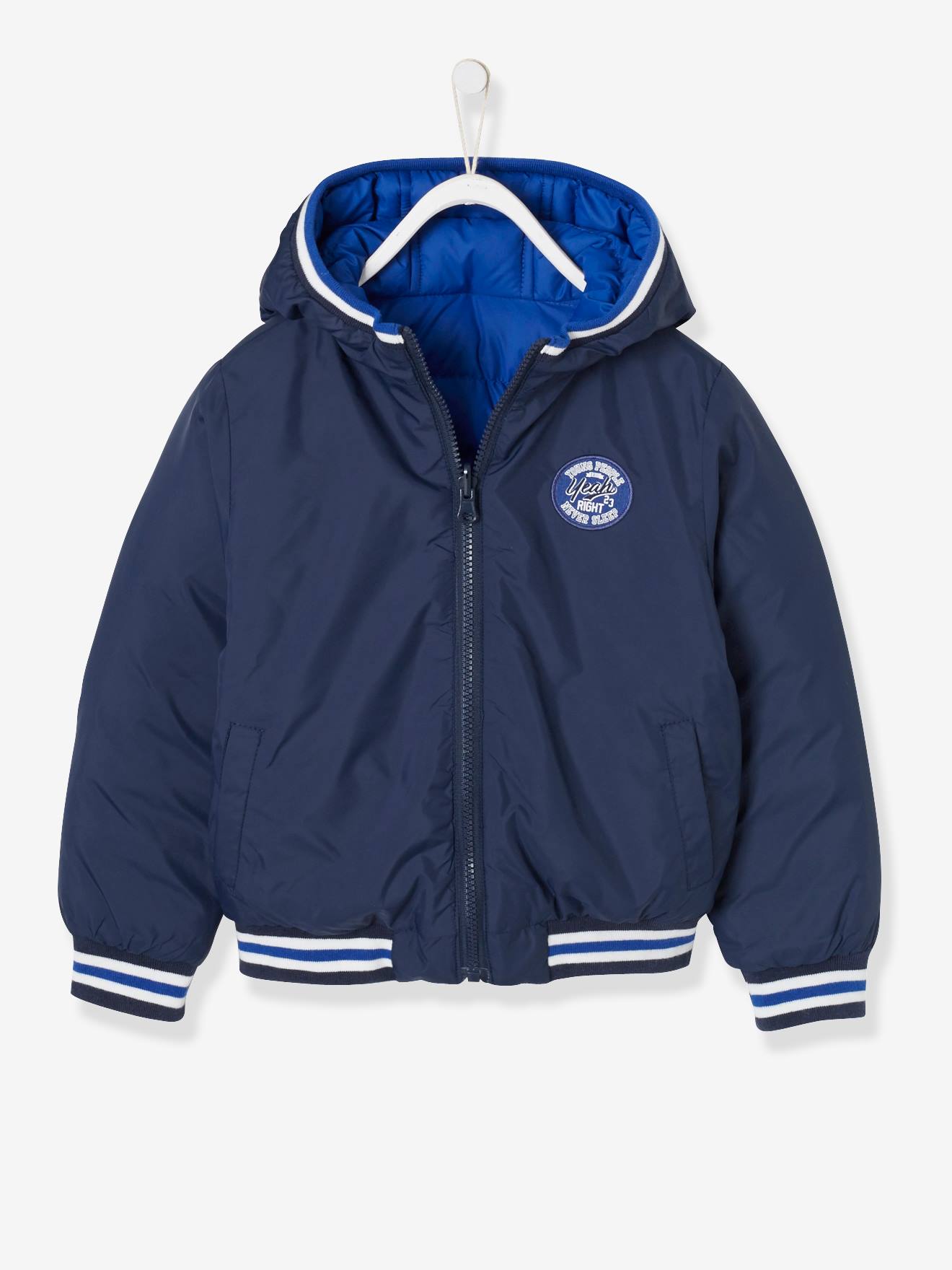 Jaqueta lisa azul-escura reversível para meninos com estampas.