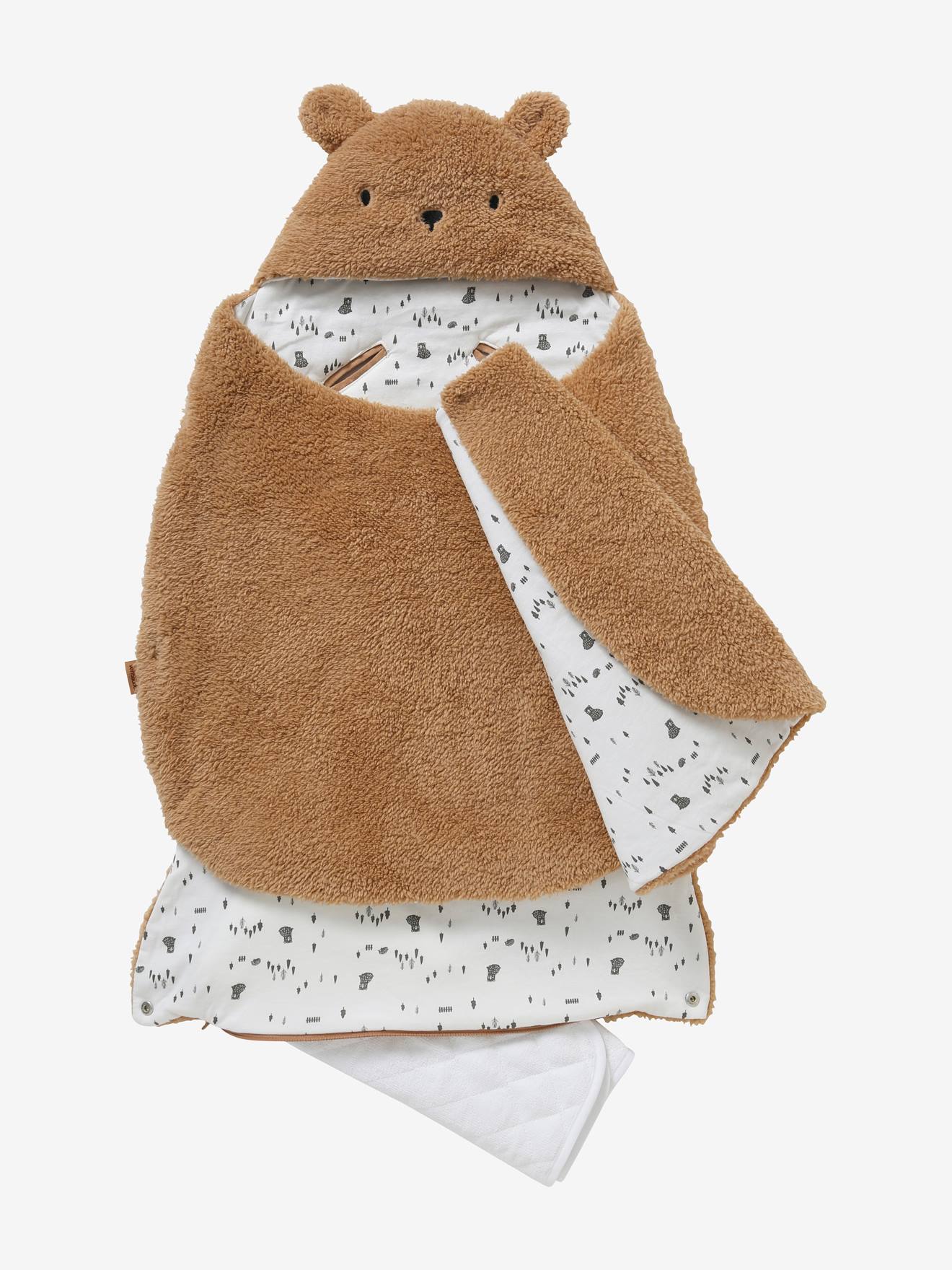 Saco transformável em brinquedo de pelúcia. Urso de pelúcia liso bege claro com estampas.