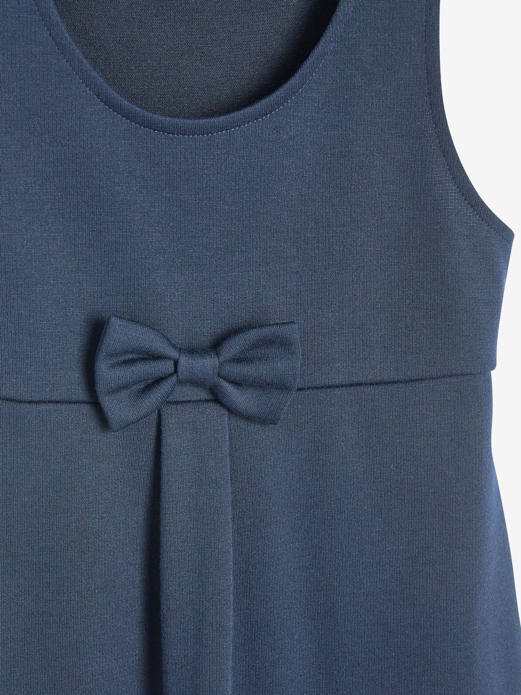 Marineblauw - Jersey stretch schoolovergooier met strik (3-16 jr)