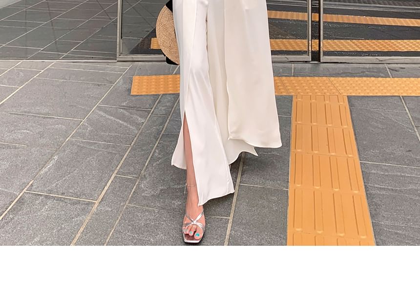 palajana - Mouwloze jumpsuit met split aan de voorkant