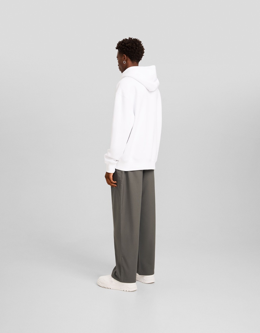 Calças de alfaiataria de pernas largas com pences.