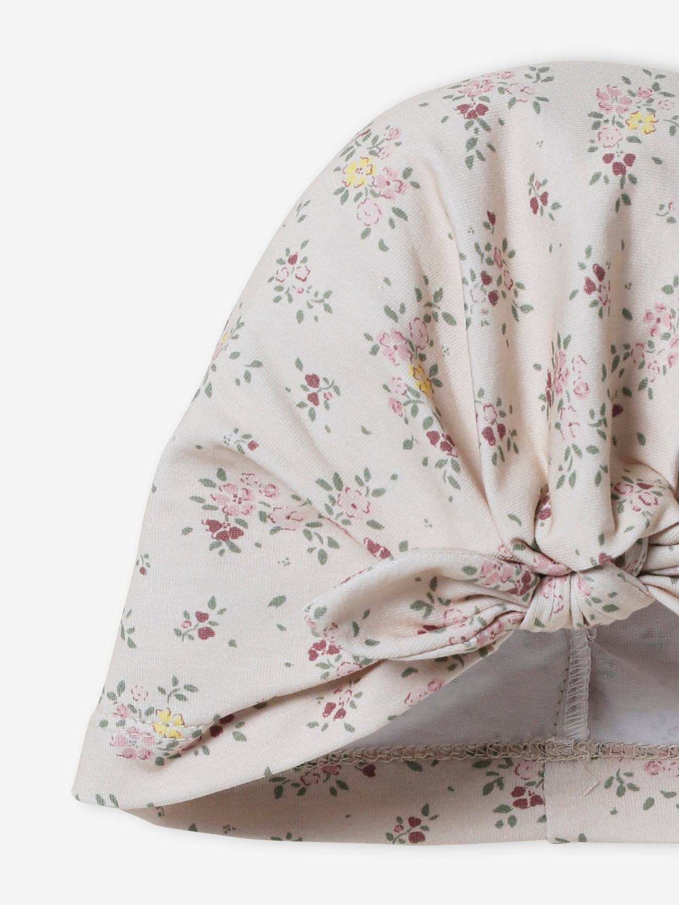 Touca infantil bege de tricô estilo turbante com estampa.