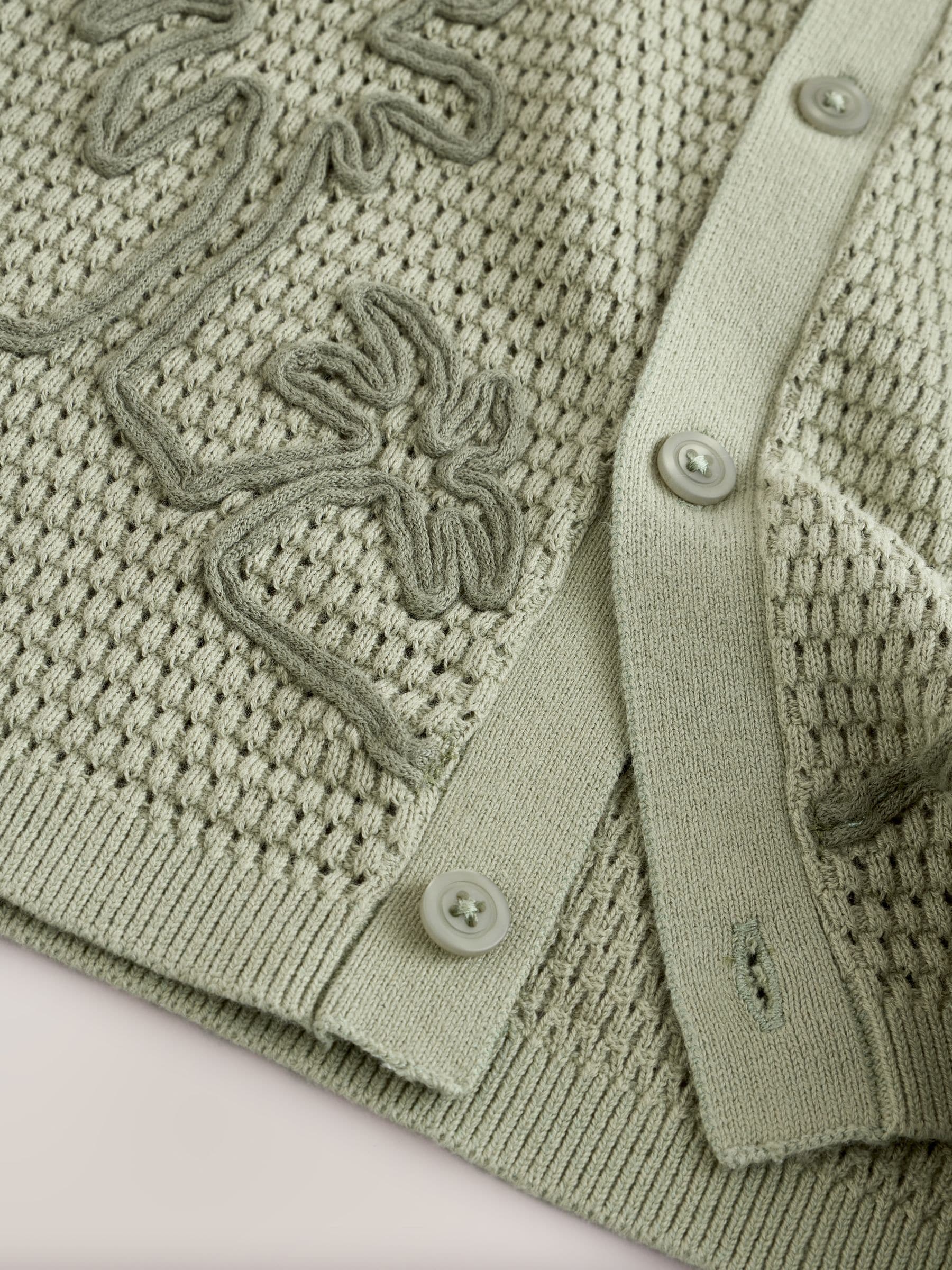 Groen met palmenprint - Gebreid poloshirt met reverskraag en korte mouwen met textuur (3mnd -7jr)