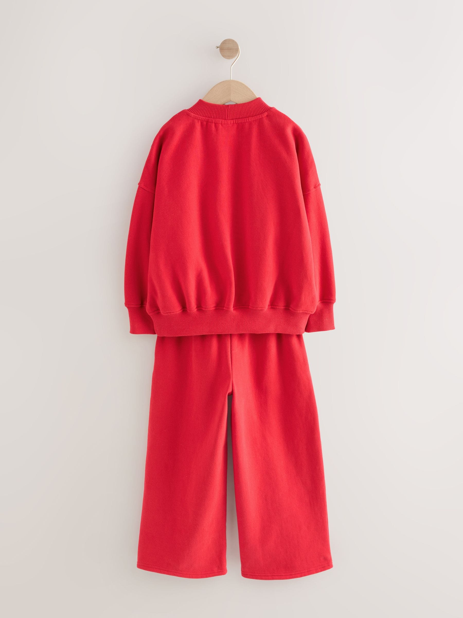 Rood met slogan - Set van sweatshirt en joggingbroek met wijde pijpen (3-16jr)
