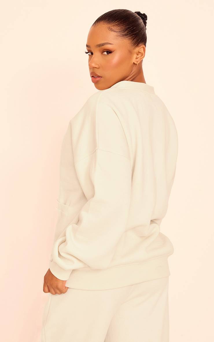 Crème Cardigan En Molleton Avec Poches Et Boutonnage Devant
