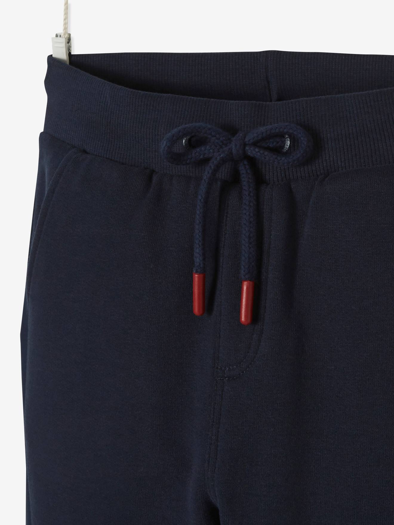 Calças esportivas infantis em dois materiais, azul-escuras lisas com estampas.