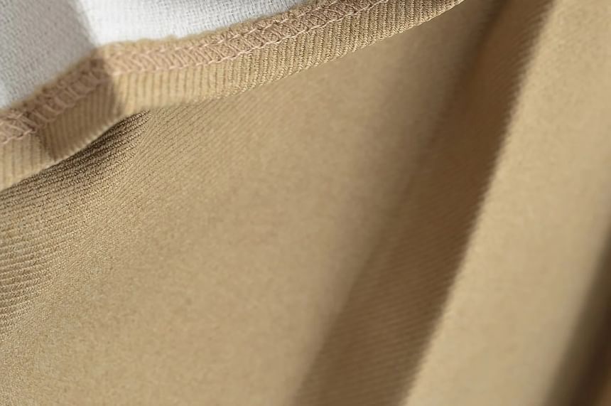 Asiris - Mini A-lijn geplooide rok met hoge taille en strikaccent