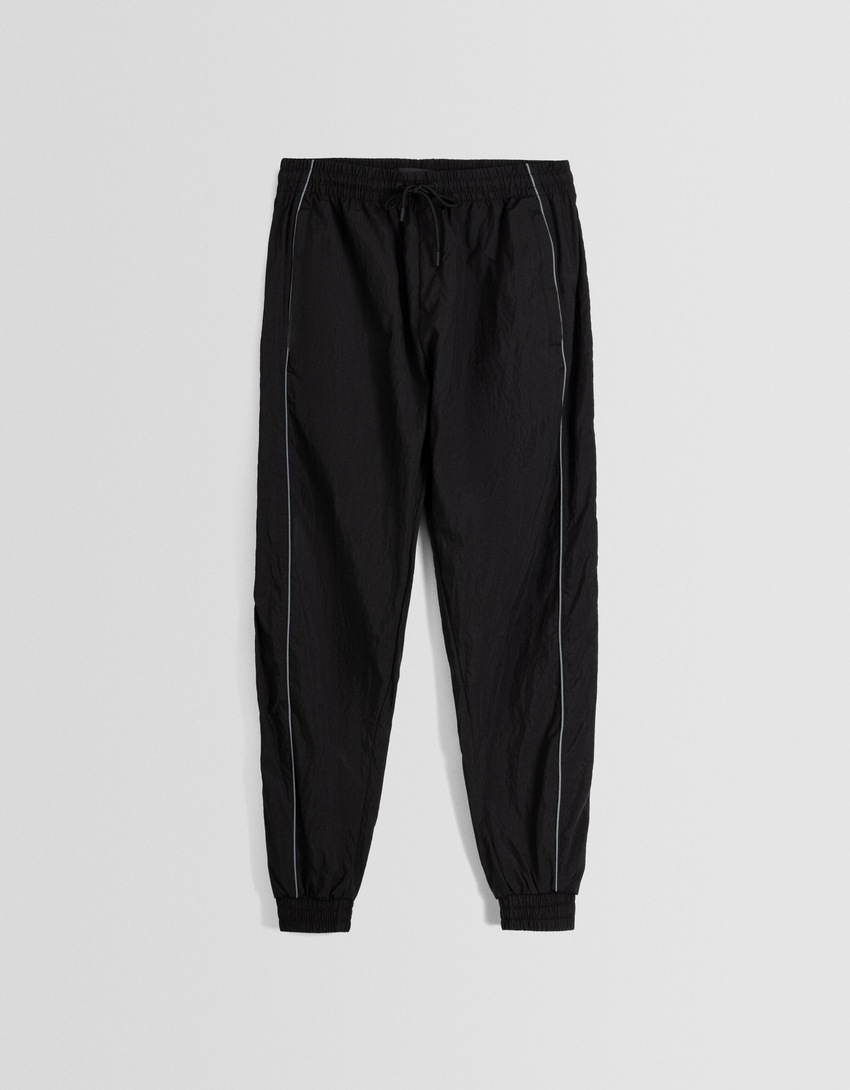 Calças de jogging técnicas com detalhes refletores