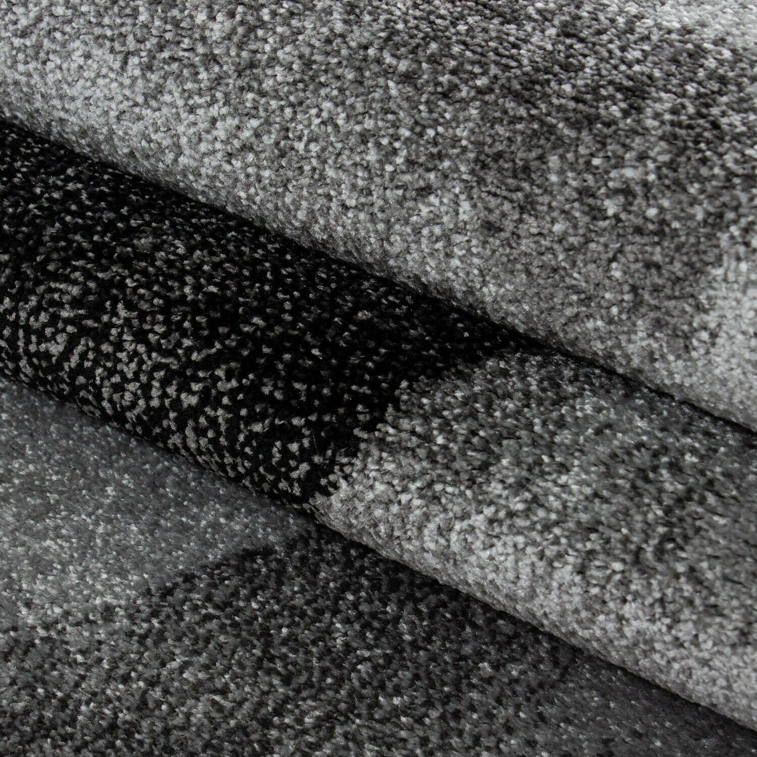 Stilvoller Designer-Kurzflorteppich mit Wellenmuster in Schwarz und Grau