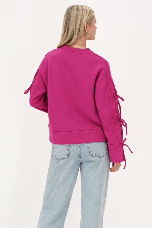 Fuchsia sweater met strikjes