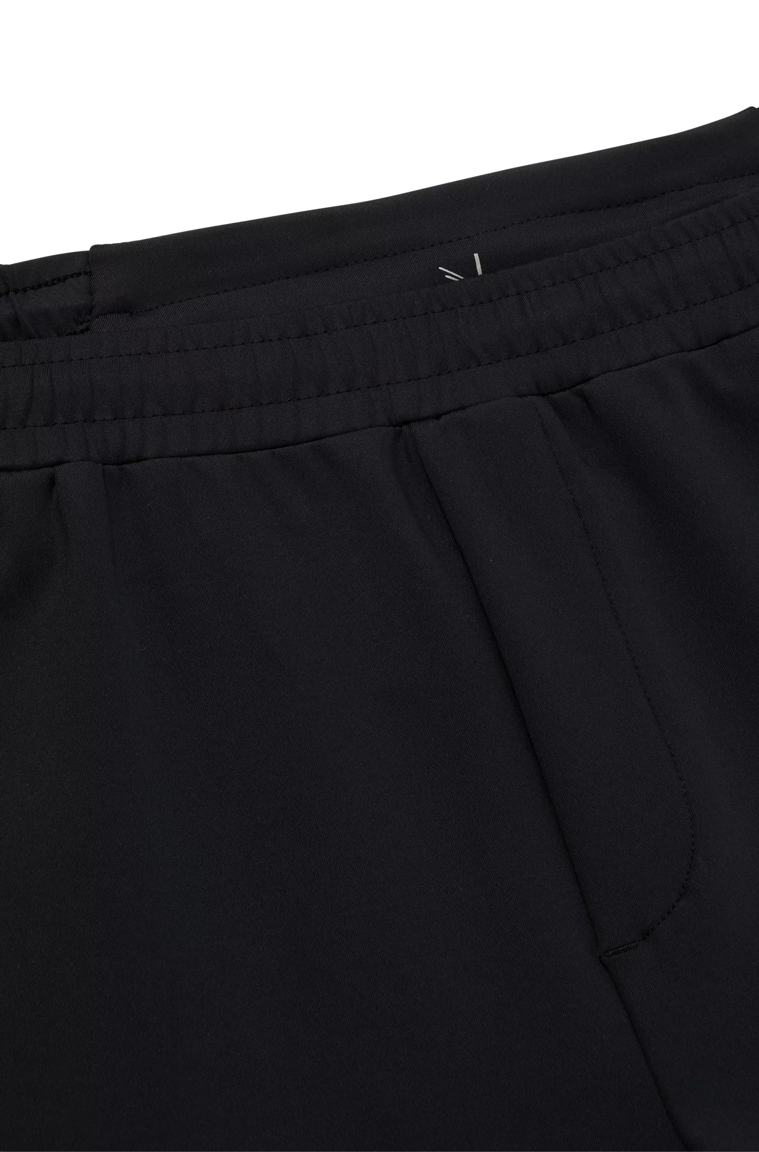 Calça de fato de treino BOSS verde com punhos, em tecido elástico para atividades físicas.