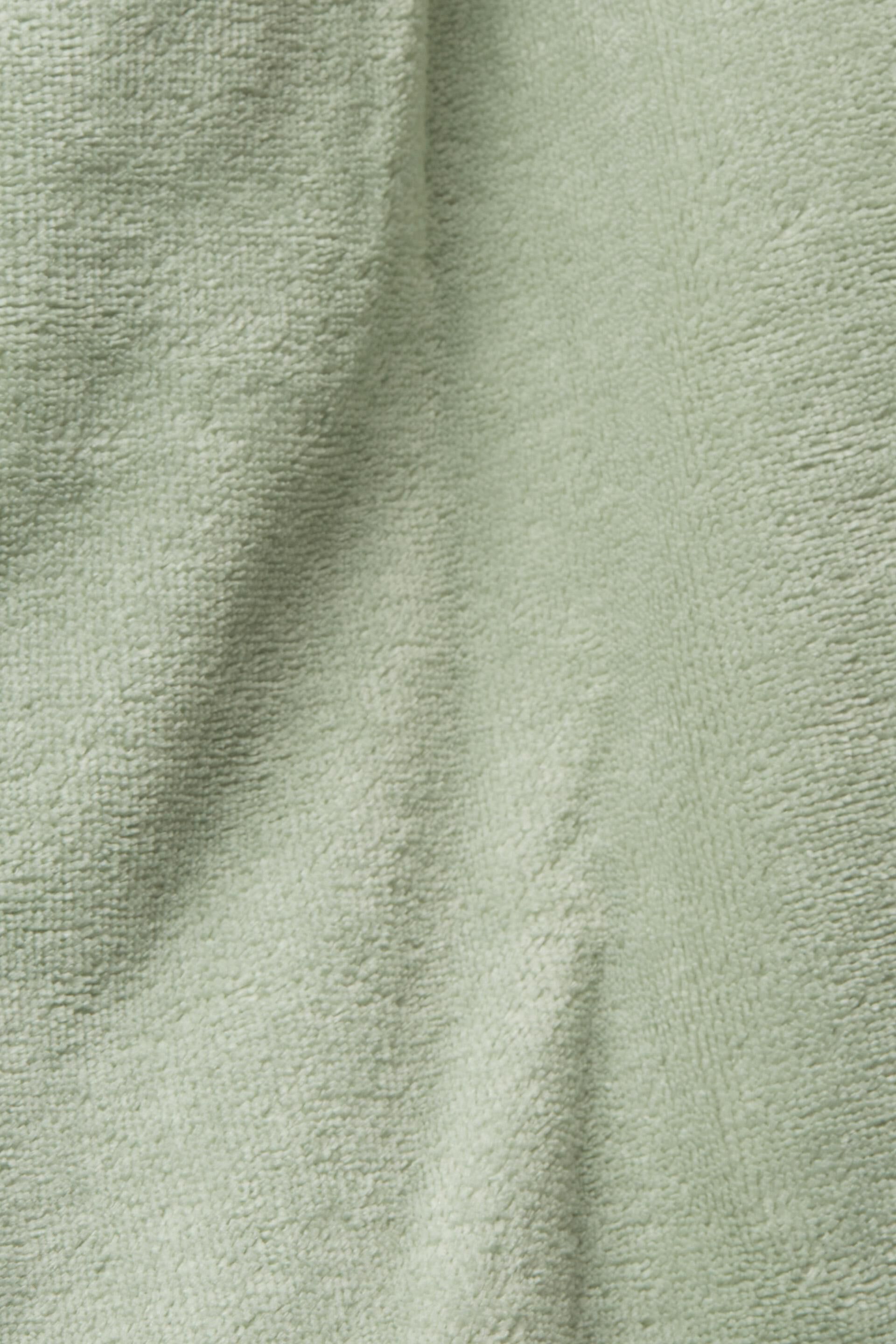 Peignoir à capuche en tissu éponge