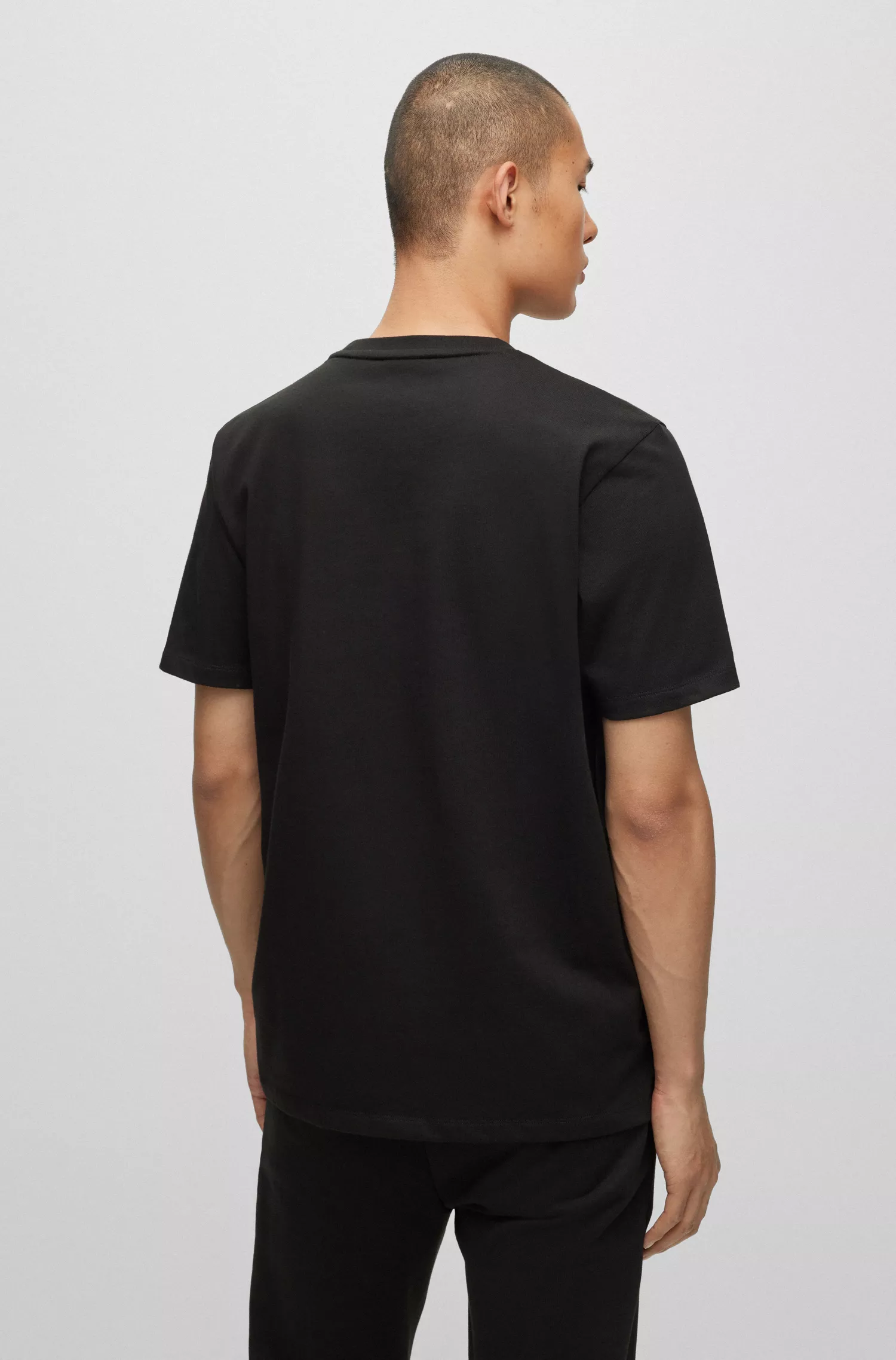 Camiseta HUGO vermelha em malha de algodão com logotipo de efeito metálico.