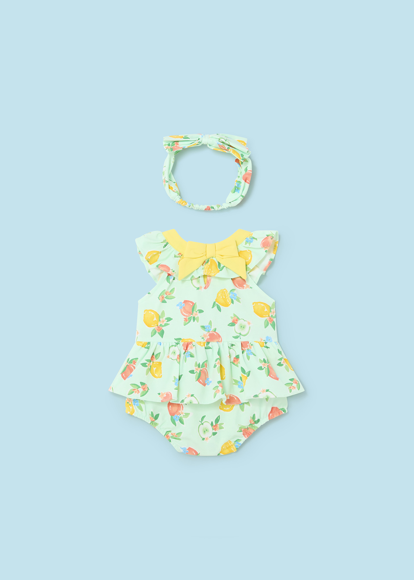 Macacão Better Cotton Juicy para recém-nascido com faixa de cabeça e estampa de frutas.