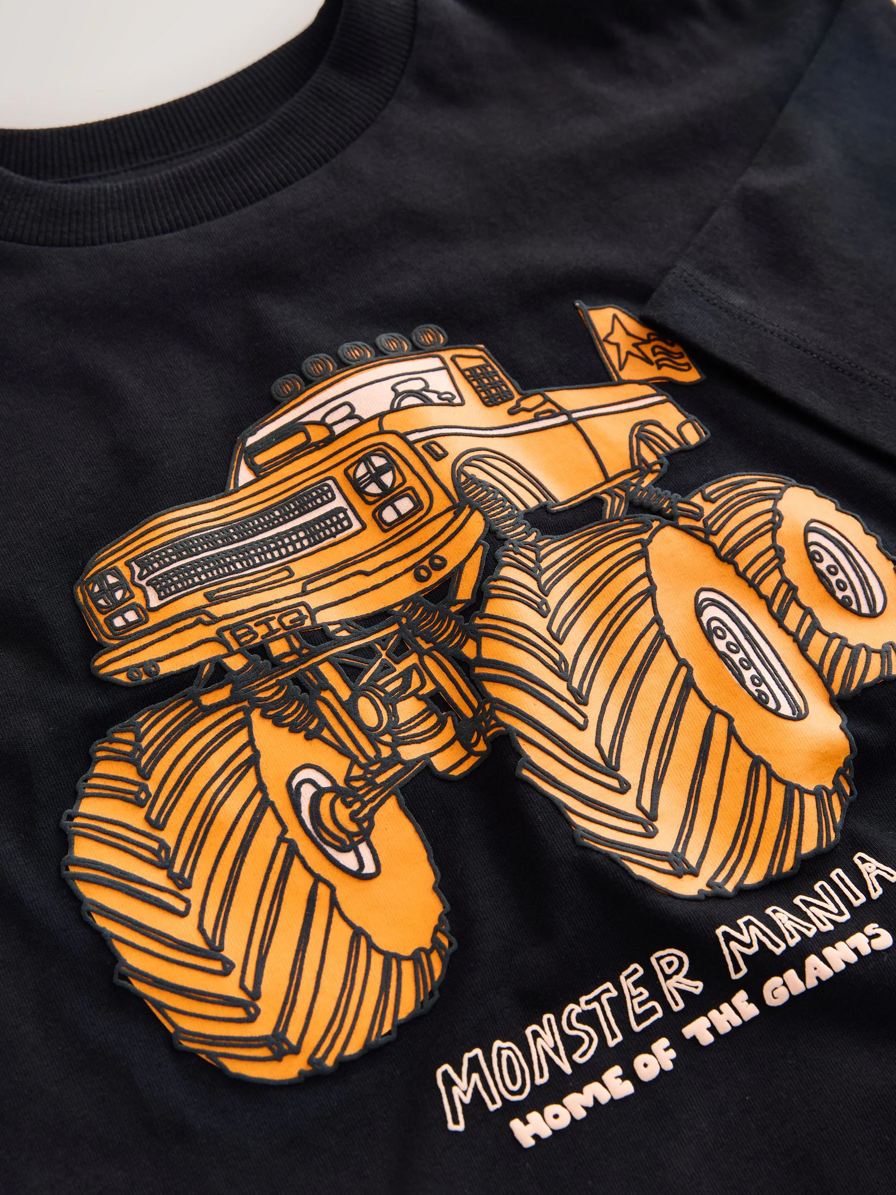 Zwart met oranje monstertruck-print - Ruimvallend T-shirt met print en korte mouwen (3-16 jr)