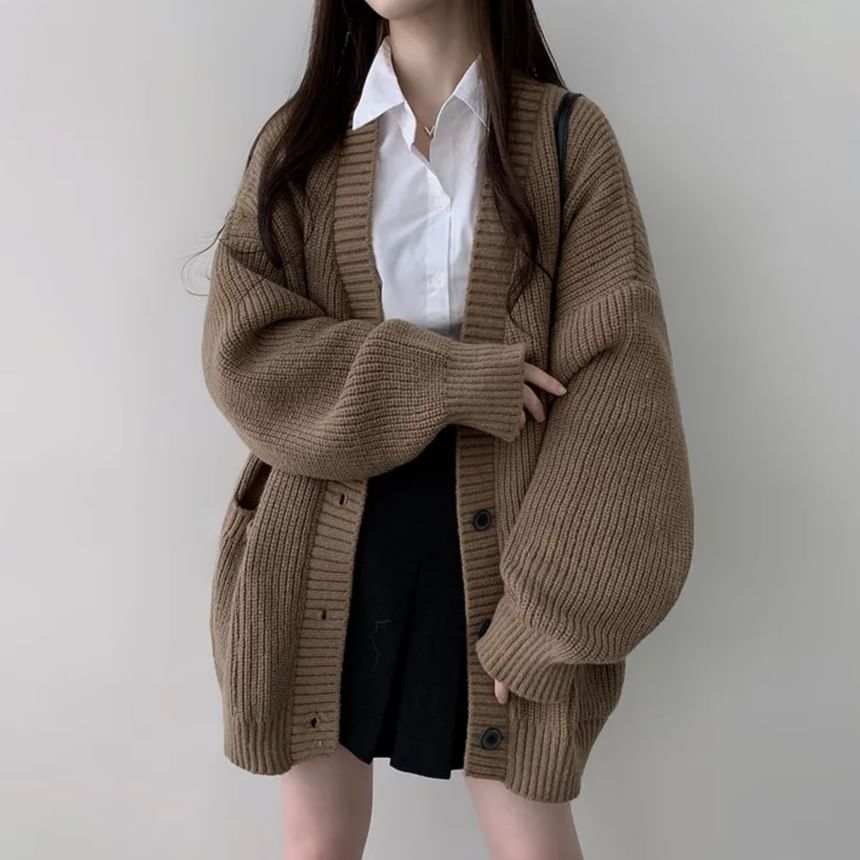 Coris - Oversized vest met pofmouwen, V-hals en effen zakdetail
