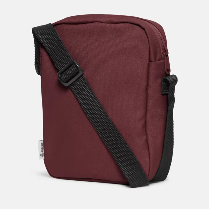 Bolsa transversal Timberland Core, unissex, na cor bordô.