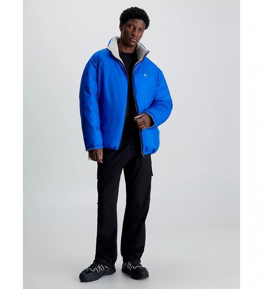 Jaqueta reversível de plumas Calvin Klein Jeans, azul e cinza, estilo anos 90.