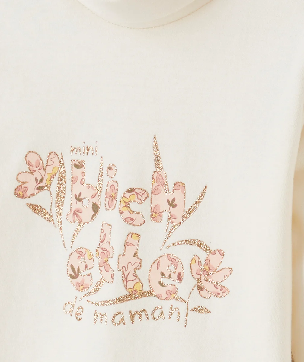 SOUS-PULL BÉBÉ FILLE COL ROULÉ EN COTON BIO ÉCRU ET MESSAGE PAILLETÉ