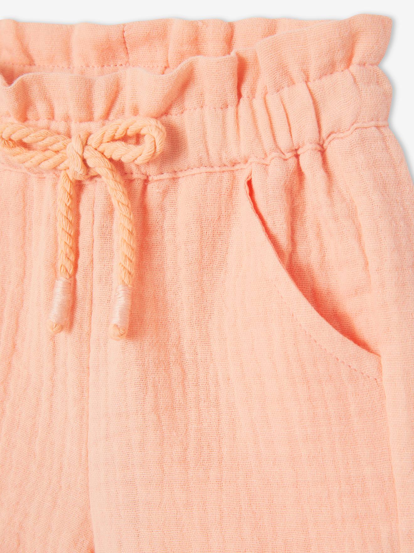 Calções de bebé com cintura elástica em chiffon de algodão liso cor laranja claro.