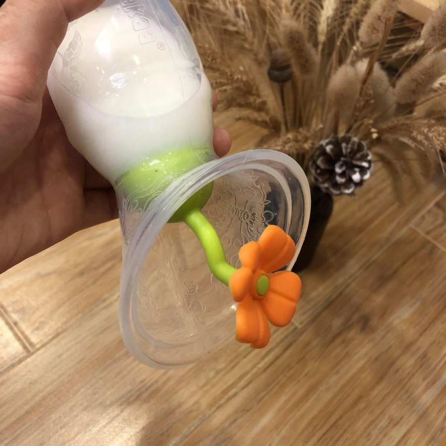 haakaa® Milchpumpe mit Saugfuß 100ml inkl. Blumenverschluss in orange