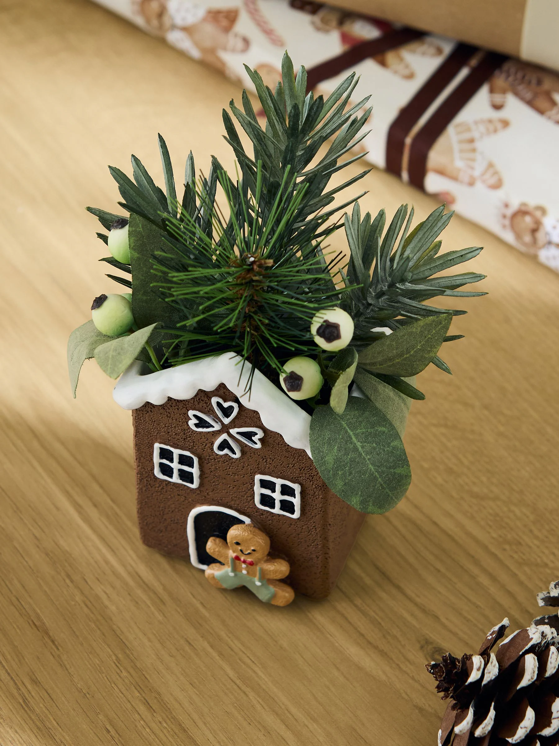 Kunstmatige winterse bladeren in een peperkoekenhuisje