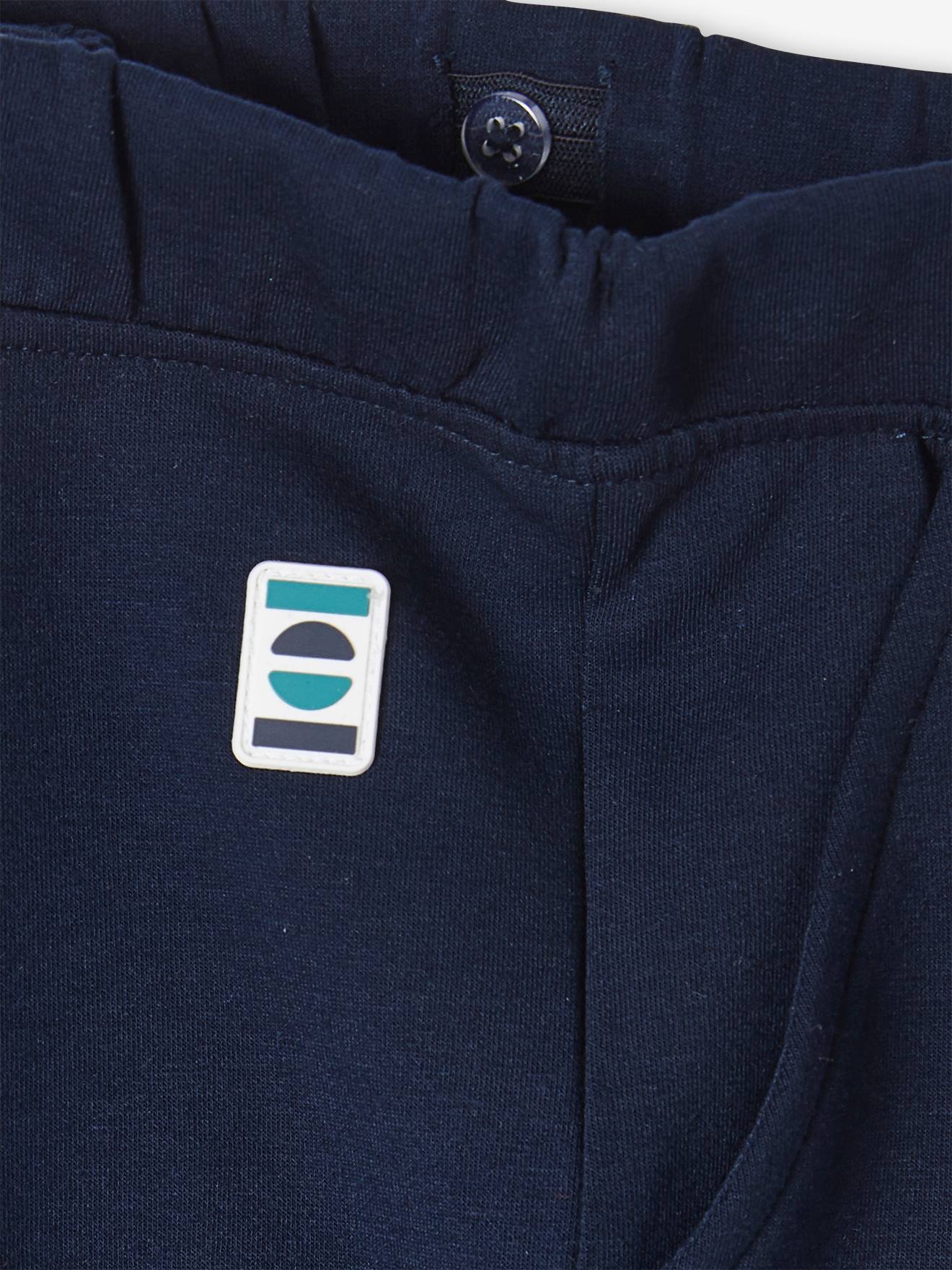 Calças de fato de treino lisas azul-escuras para meninos com estampas.