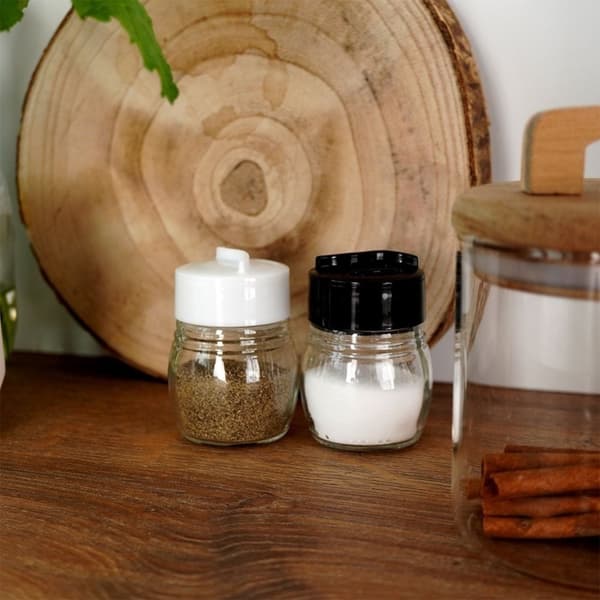 Salt- og pepperbøsse i glass med justerbare åpninger