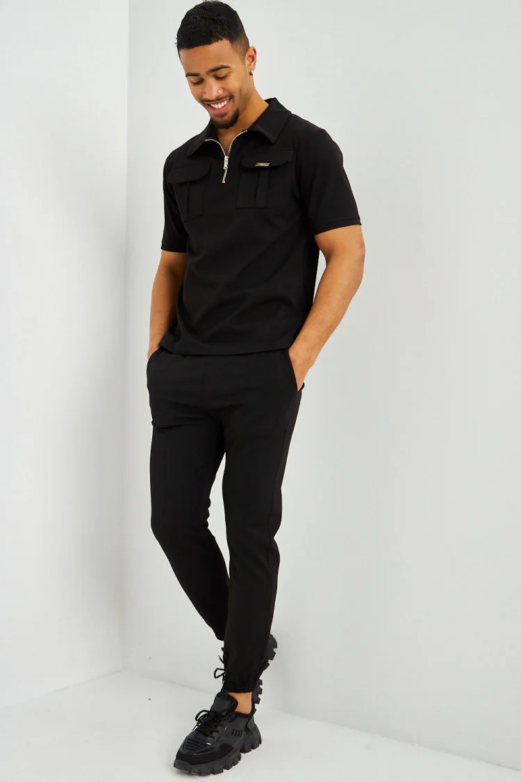 Polo uni noir col zippé à poches