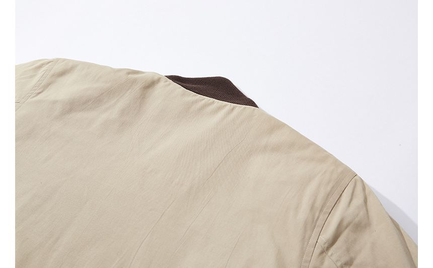 OKONKWO - Tweekleurige gewatteerde jas met knopen