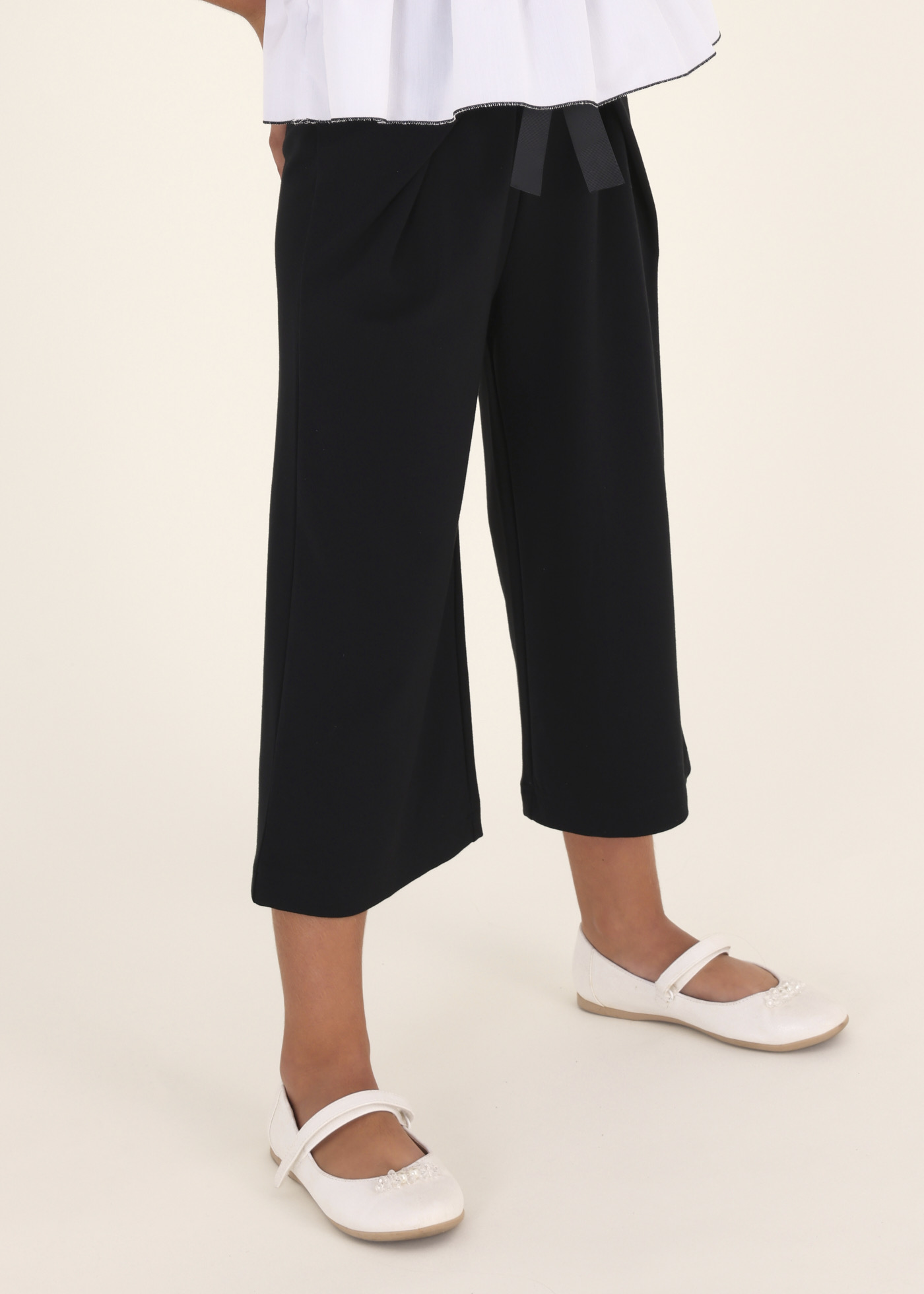 Calças cropped com amarração em malha Roma para meninas