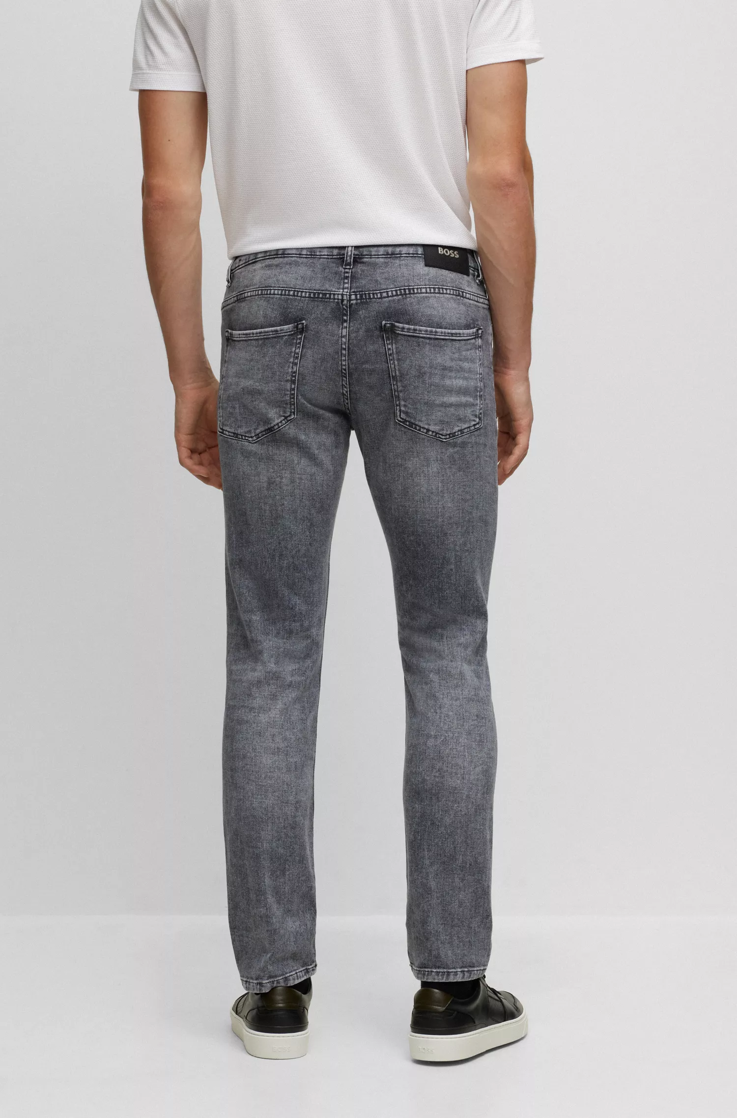 Calça jeans BOSS preta, corte slim, em denim italiano stretch cinza lavado.