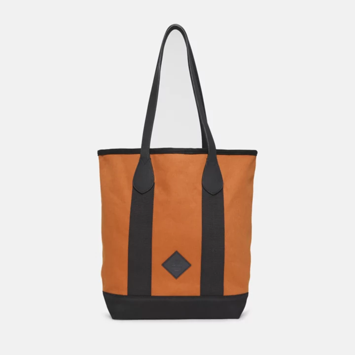 Bolsa tote feminina em lona e couro na cor marrom.
