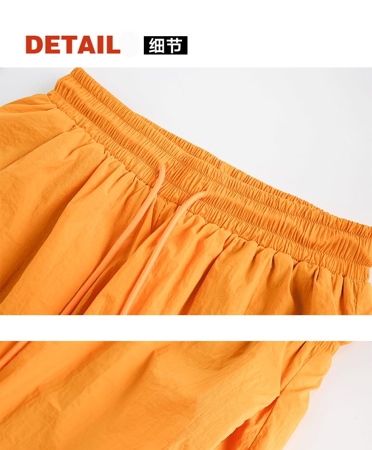 Hushgrain - Wijde shorts met hoge taille en letters