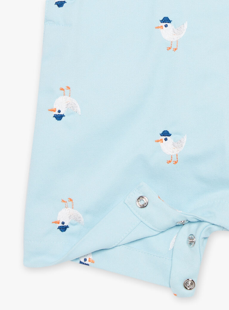 Salopette courte bleue à imprimé oiseau
