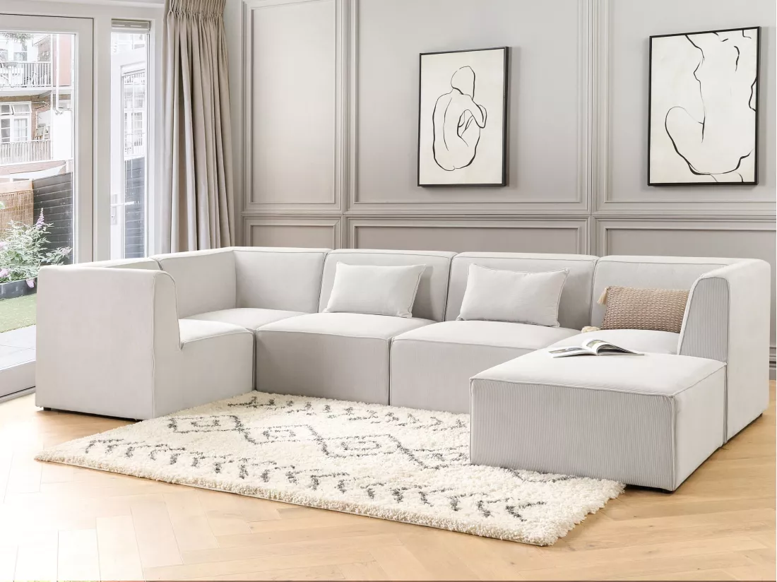 Canapé d'angle côté droit modulable 5 places en velours côtelé blanc cassé avec ottoman LEMVIG
