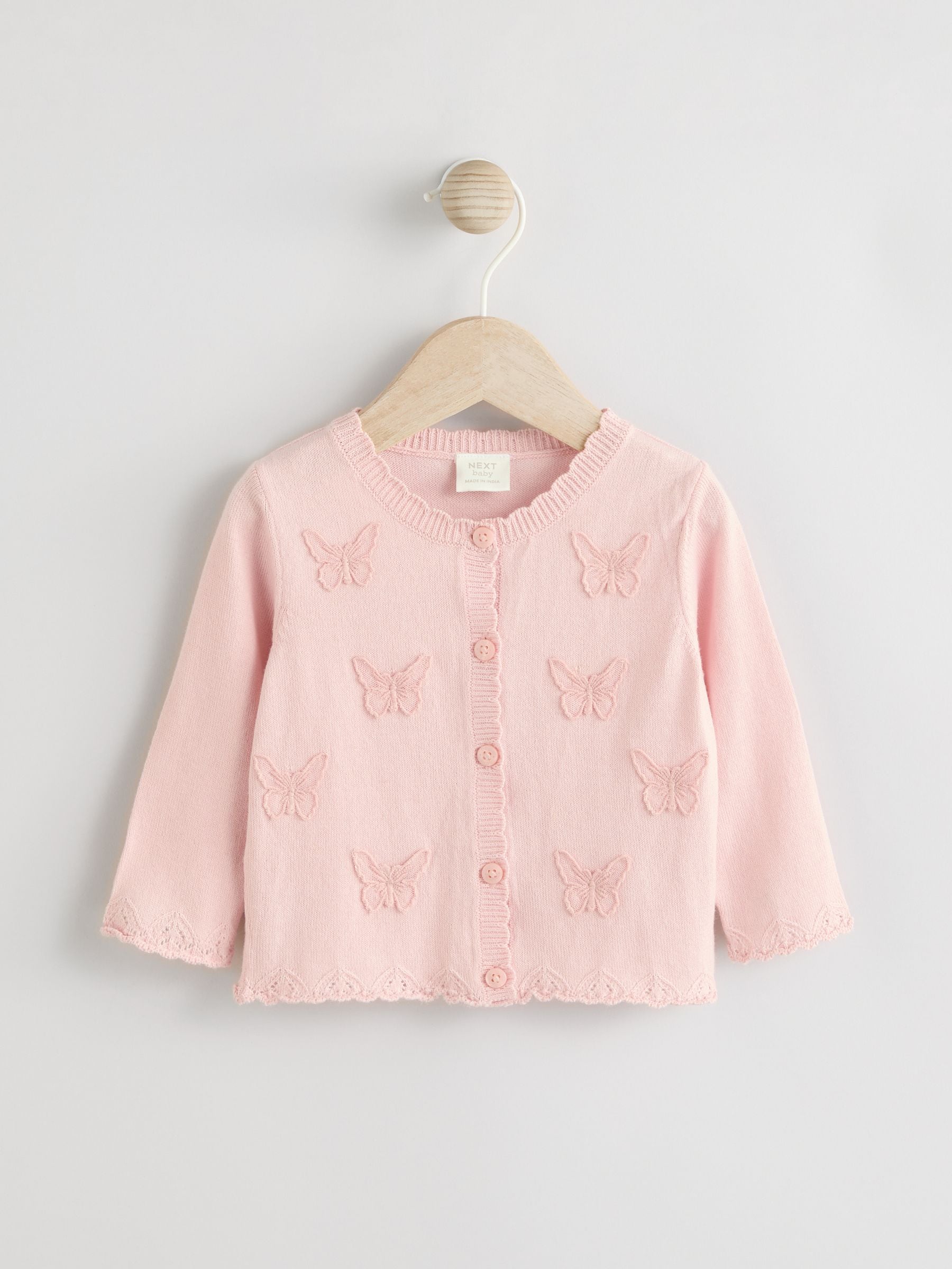 Roze vlinderborduursel - Gebreid babyvest (0 mnd- 2 jr)