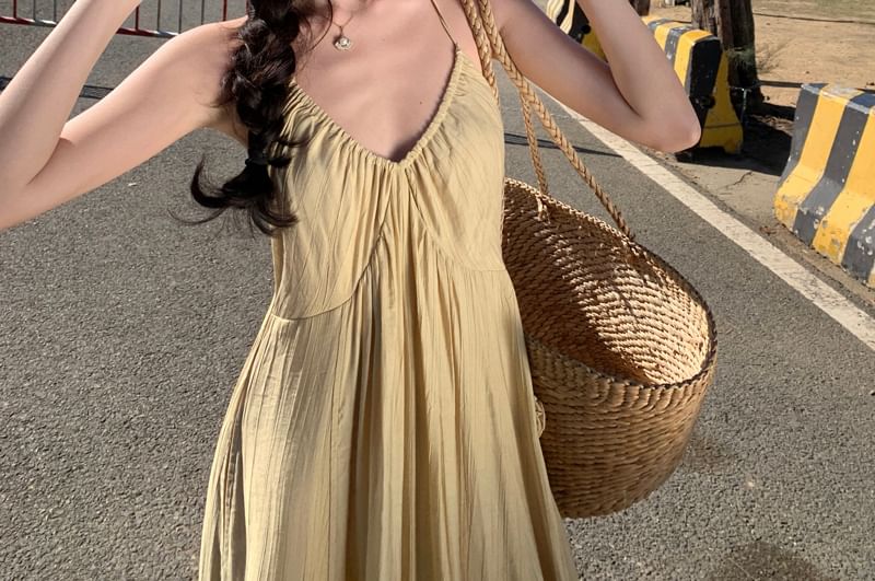 Lydiah - Spaghettibandjes jumpsuit met bloemenaccent en wijde pijpen