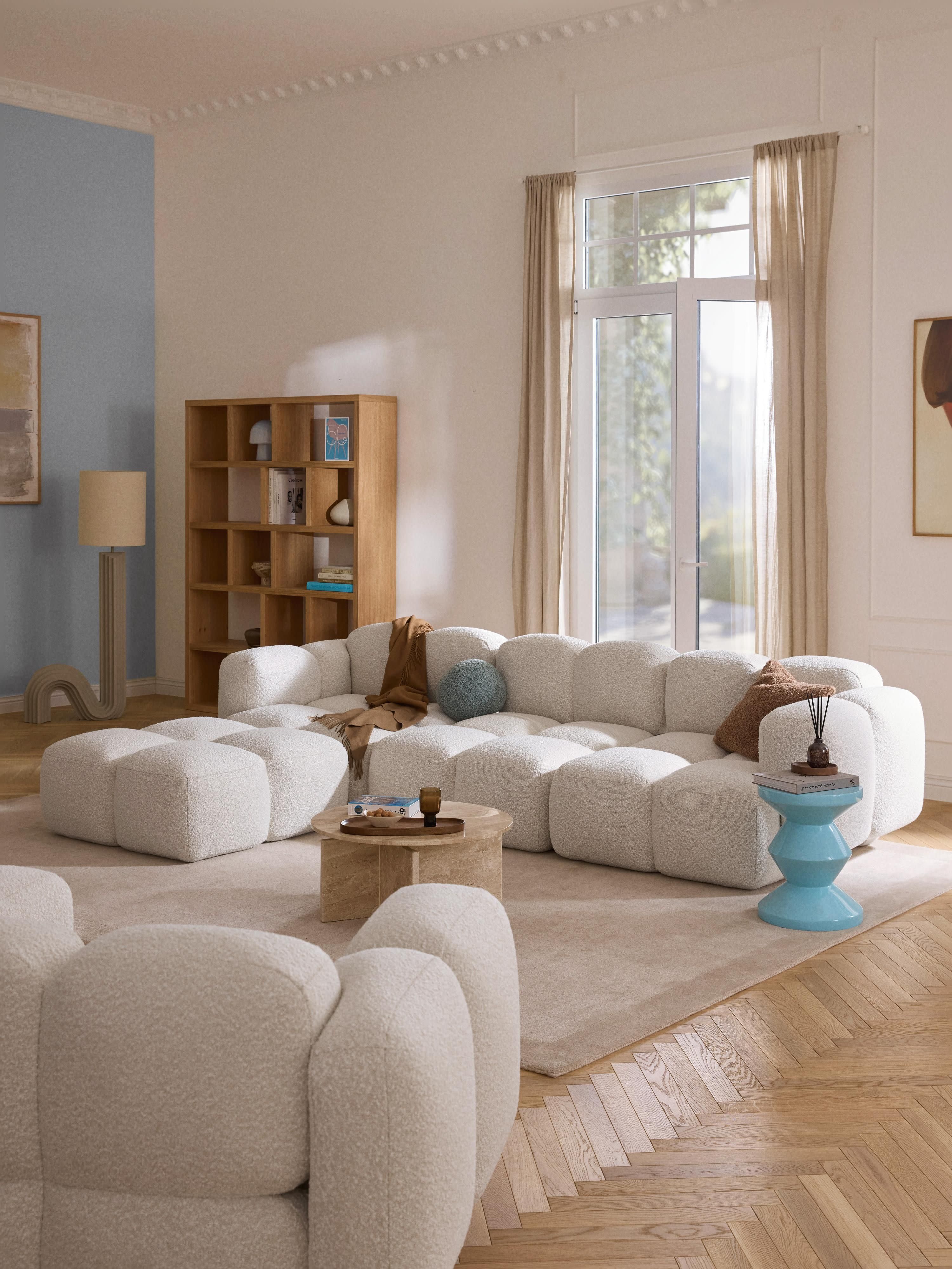 Modulaire bank Tayla (4-zits) van bouclé met poef (links/rechts)