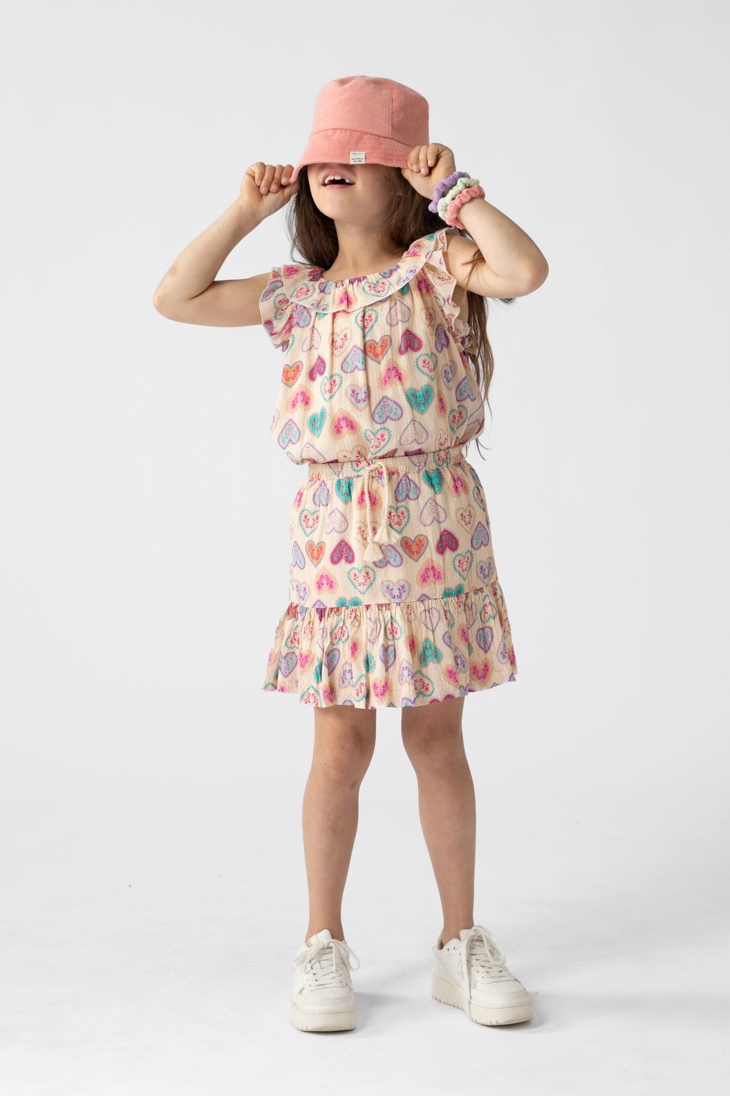 Lichtoranje top met ruffles en hartjes