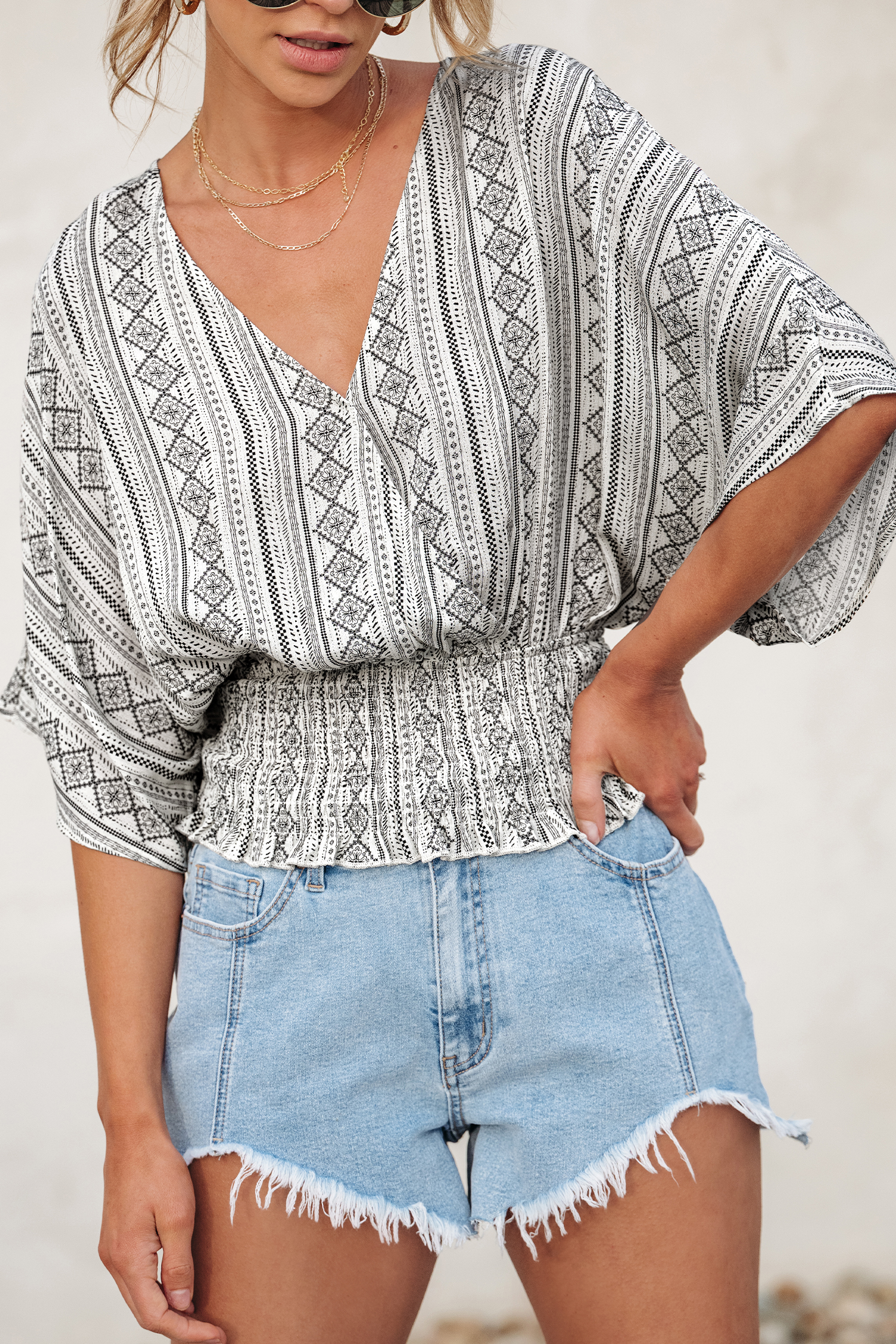 Haut avec manches dolman à smocks géométrique