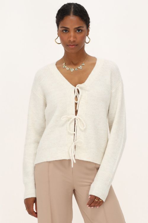 Crème vest met strikjes