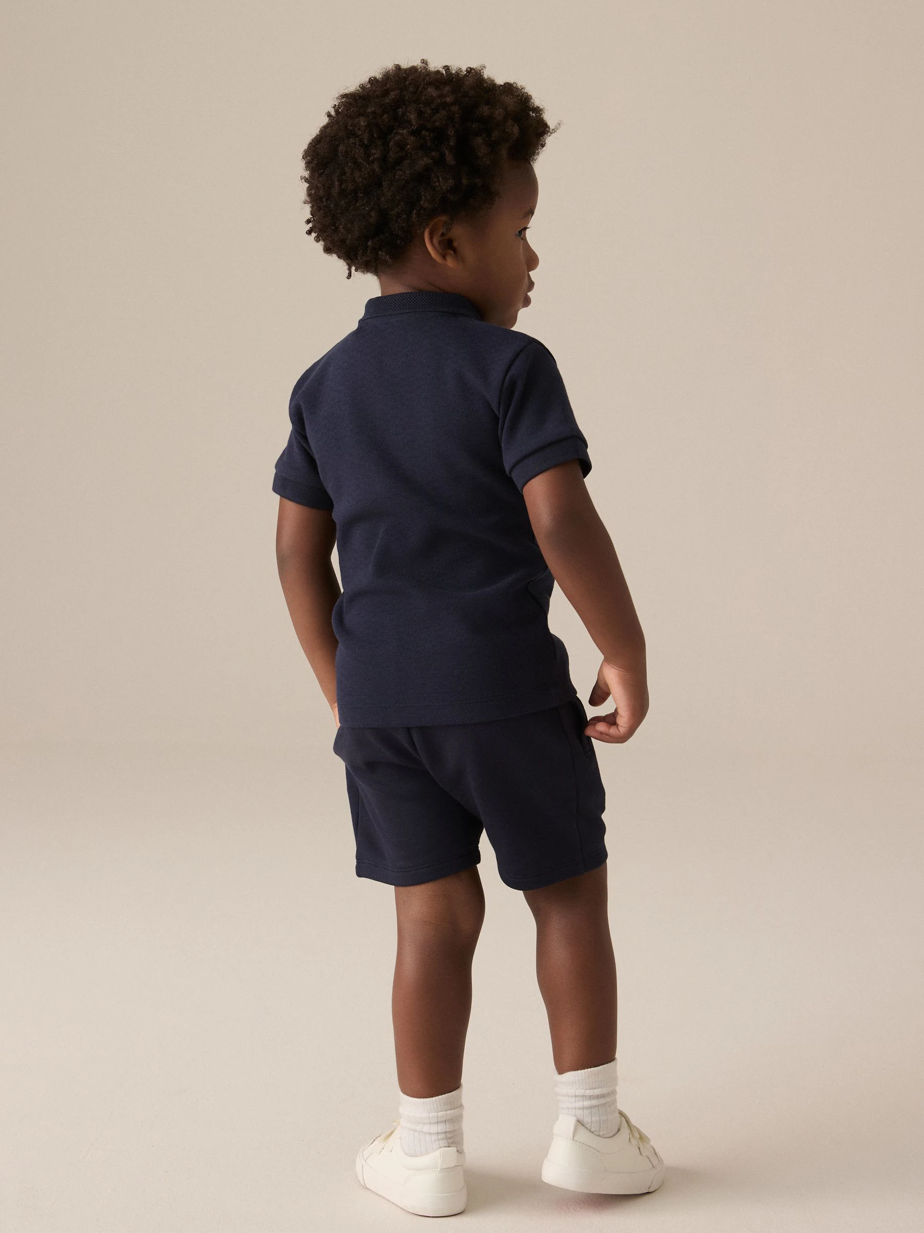 Marinablauw getextureerd - Set van poloshirt met korte mouwen, rits bij de hals en short (3mnd-7jr)