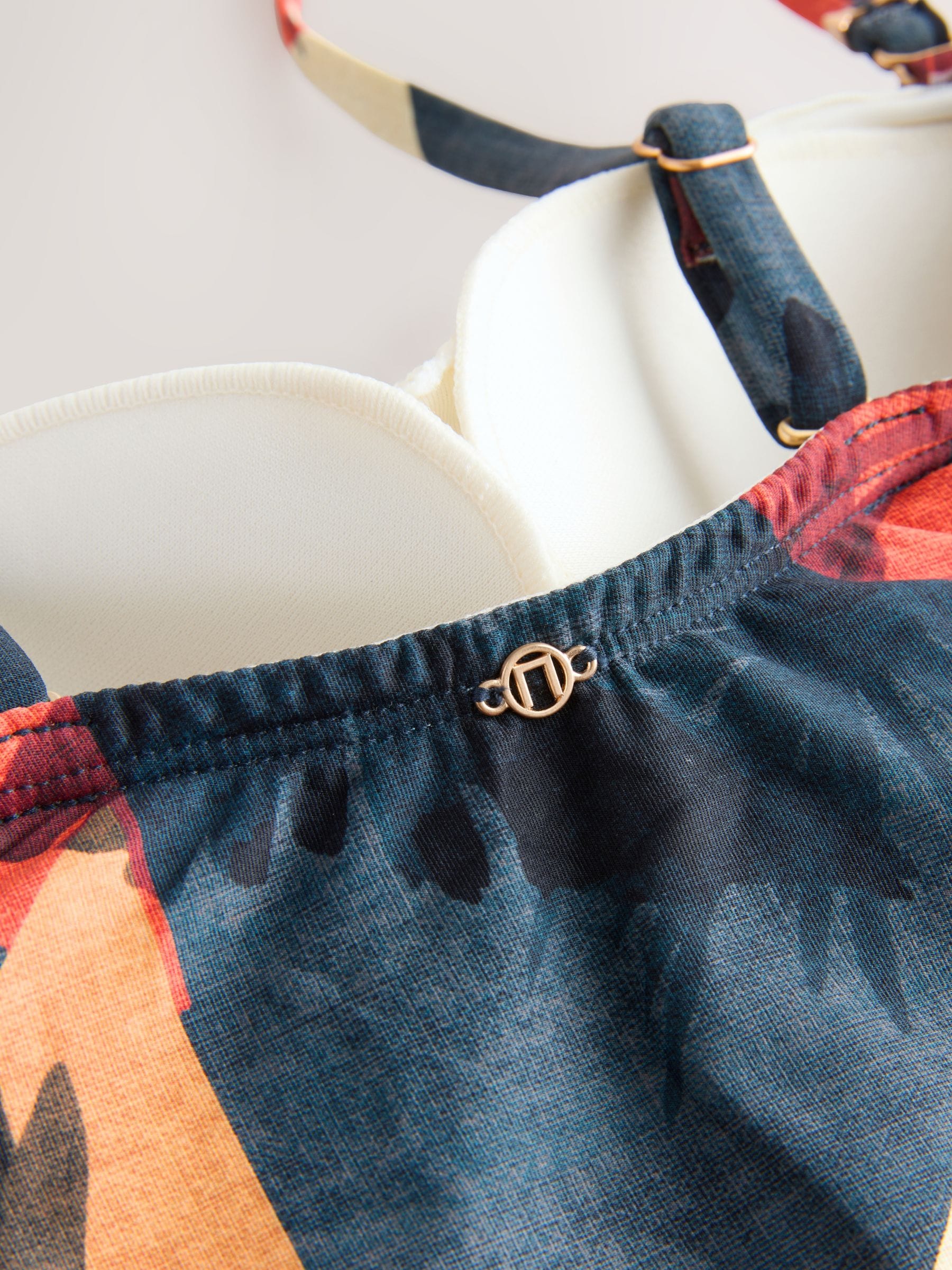 Marineblauw/oranje met palmprint - Vormgevend bandeaubadpak met buikcorrectie