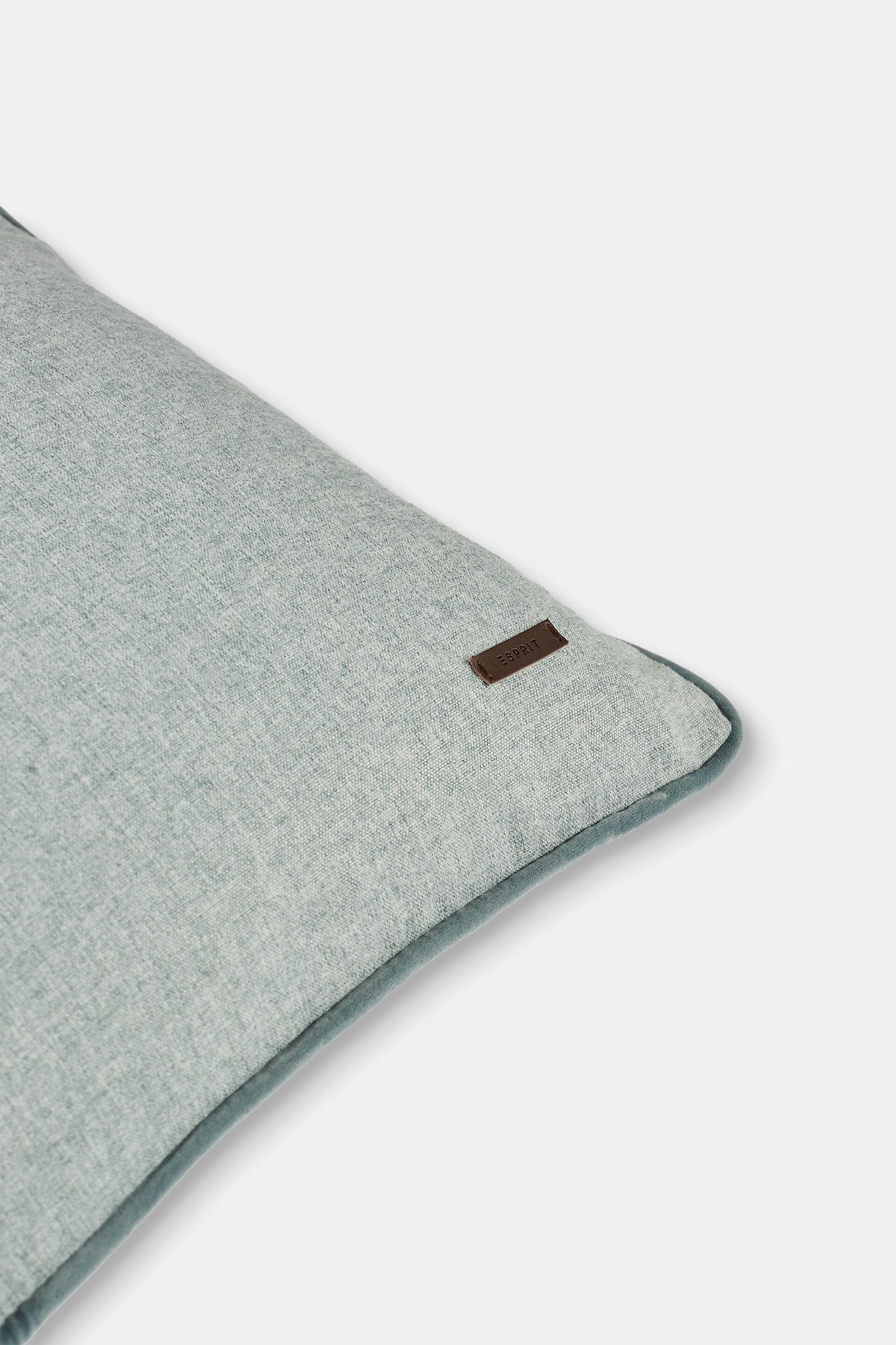Housse de coussin décorative rehaussée d’un passepoil en velours
