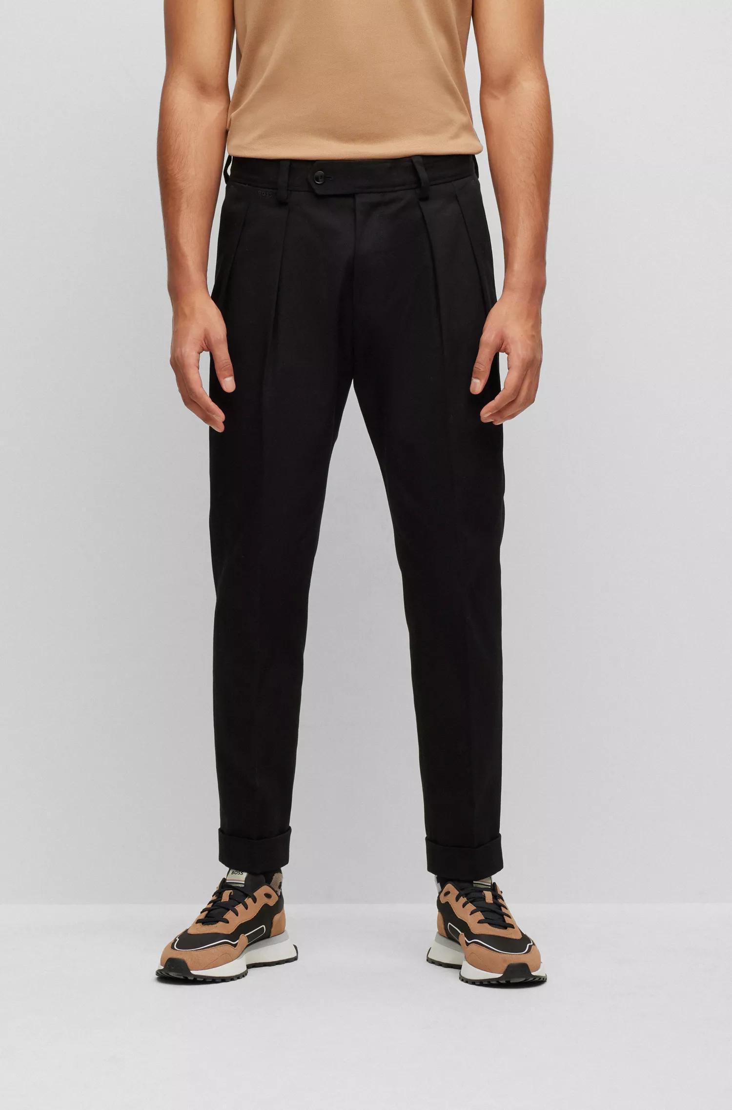 Calça BOSS preta de corte relaxado em algodão elástico com prega frontal.