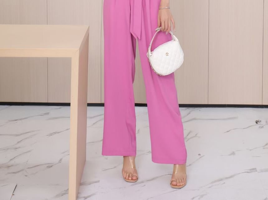 Yolandus - Jumpsuit met wijde pijpen en imitatieparelbandjes en strikceintuur