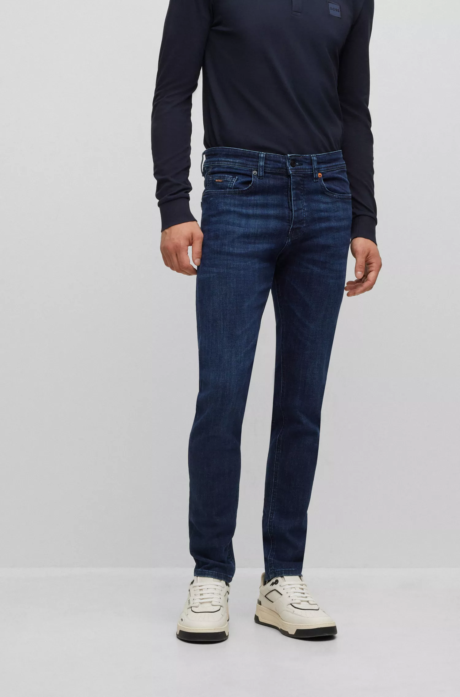 Calça jeans BOSS laranja, corte afunilado, em denim superelástico azul-escuro.